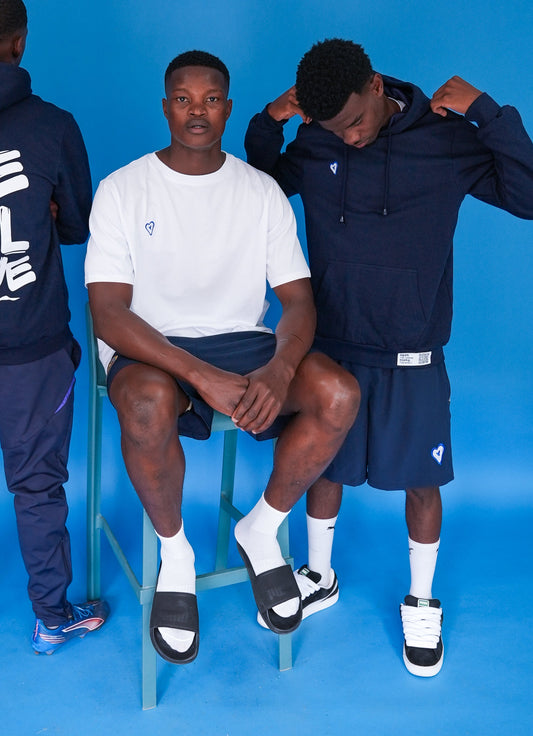 Three individuals wearing athletic wear against a blue background
